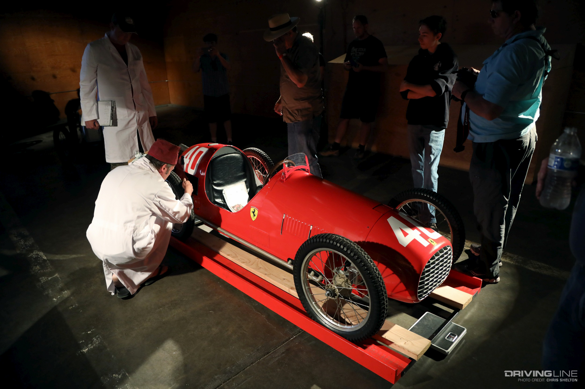 man in fez and Ferrari-branded cyclekart