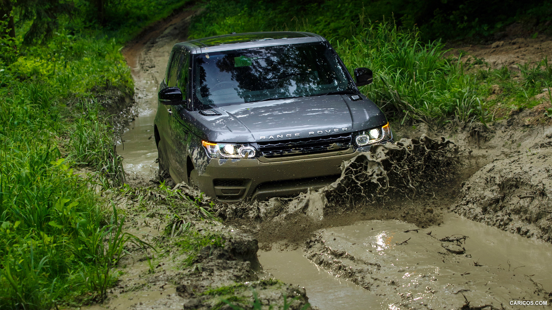 Range Rover Driving Through a Muddy Wash