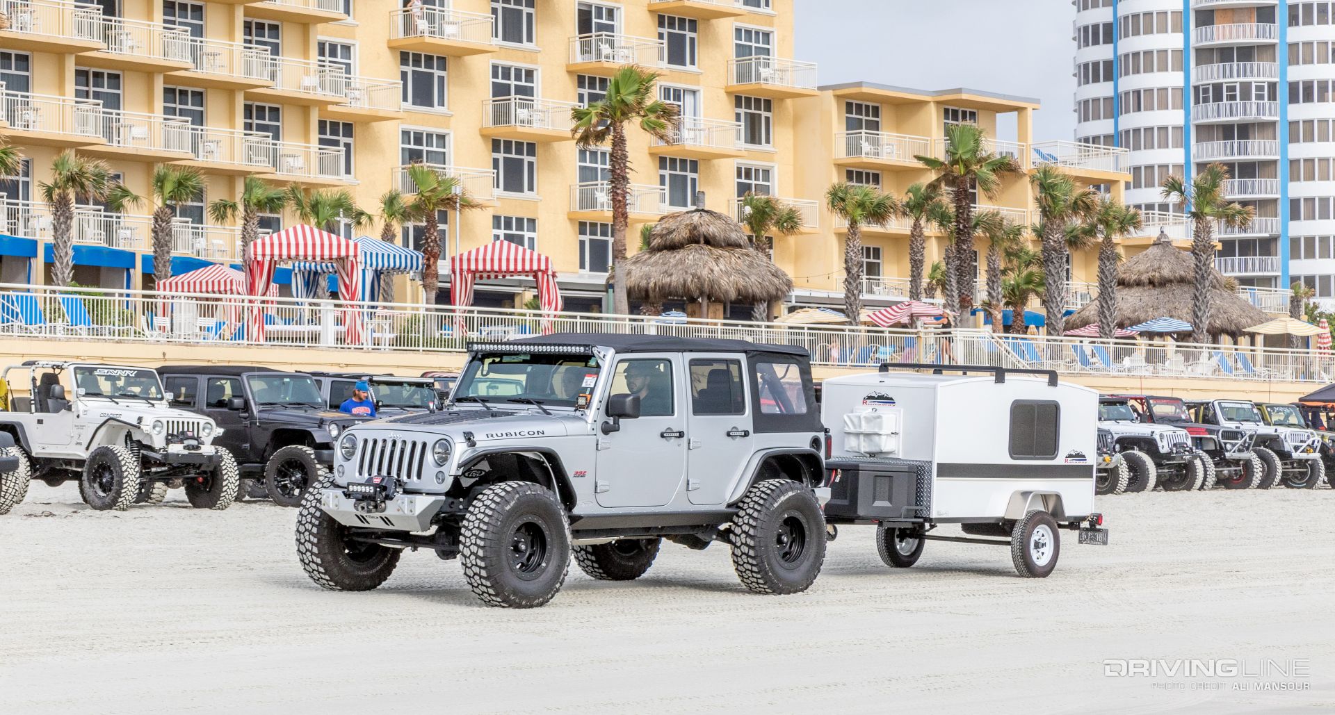Jeeps in front of a hotel next to the beach at Jeep Beach