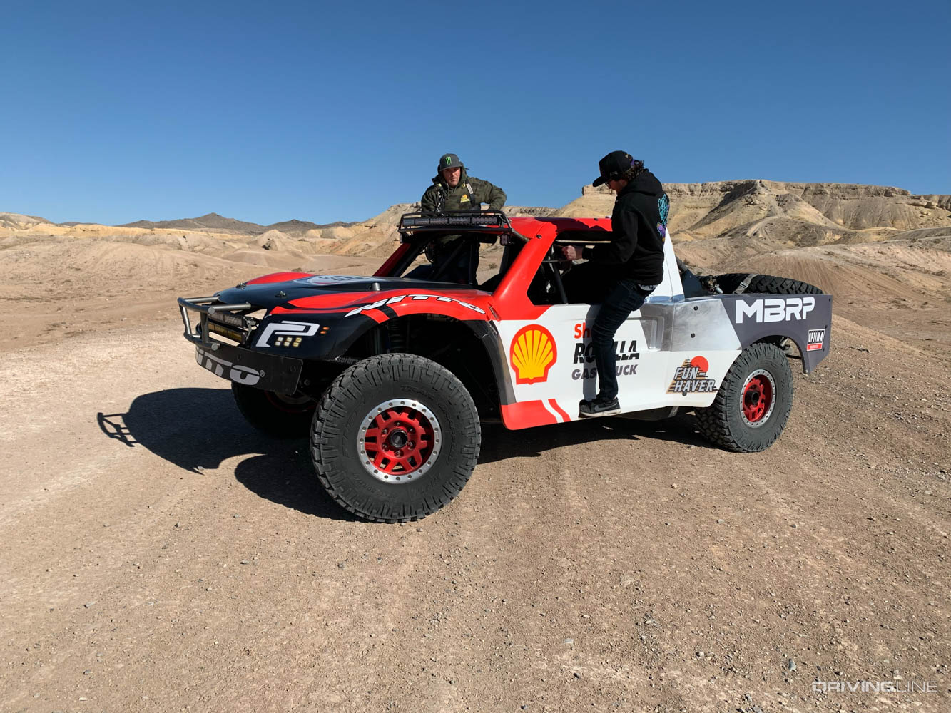 Chelsea getting behind the wheel of a desert spec racing truck with Nitto Trail Grappler tires