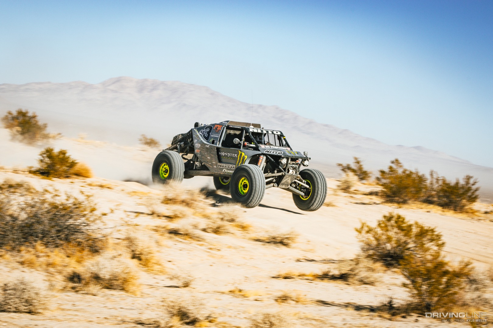 Wayland Campbell driving his rig over a hill