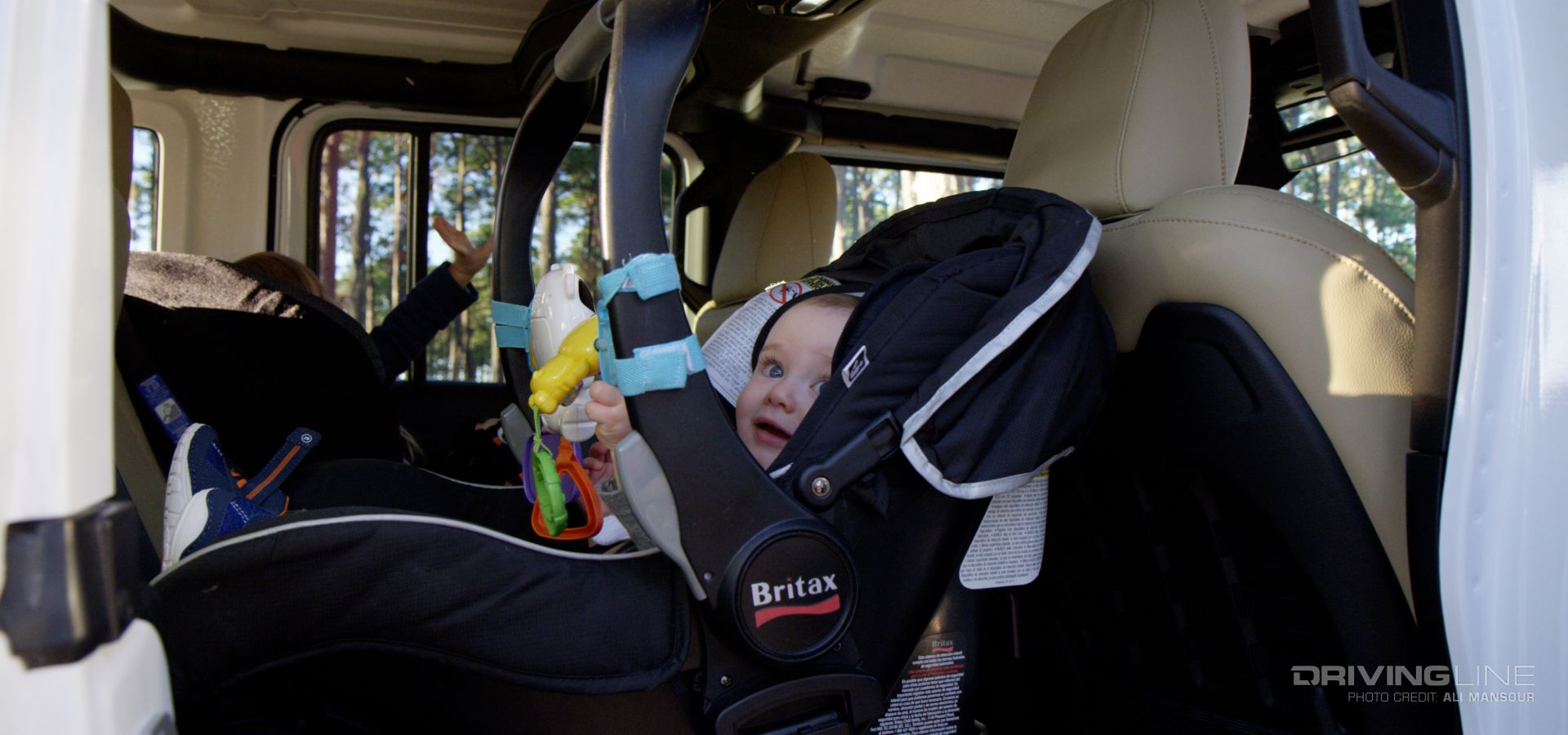 Jeep Wrangler with baby in the backseat