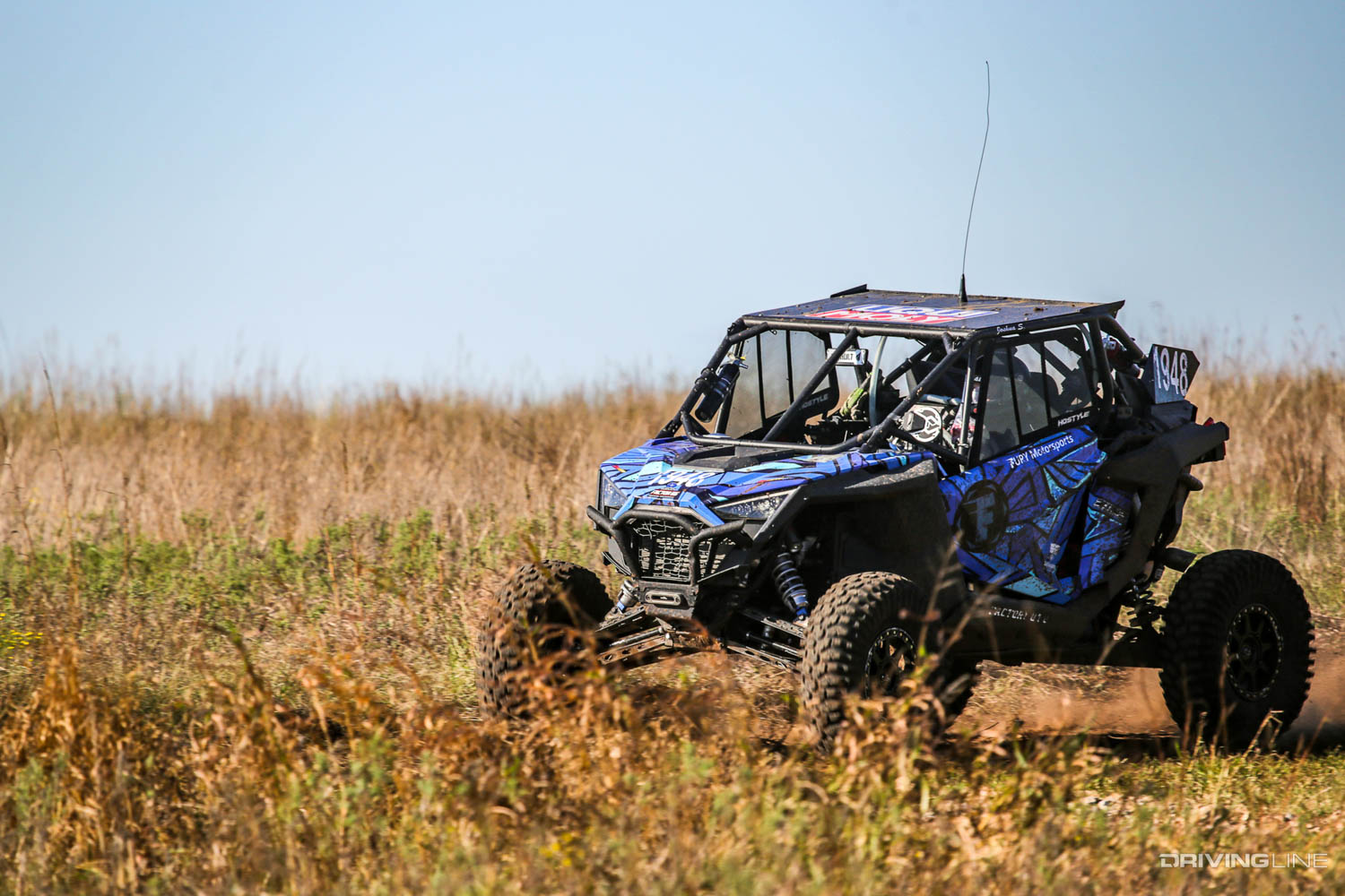 Joshua Smith driving through tall grass