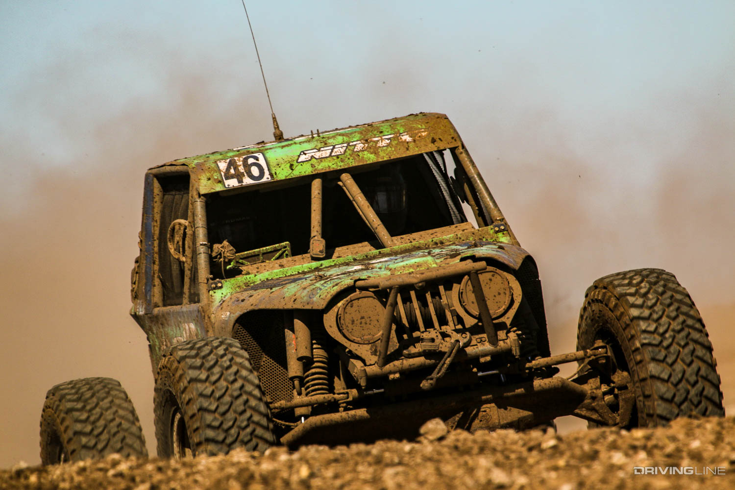 Rusty Blyler driving over a small hill