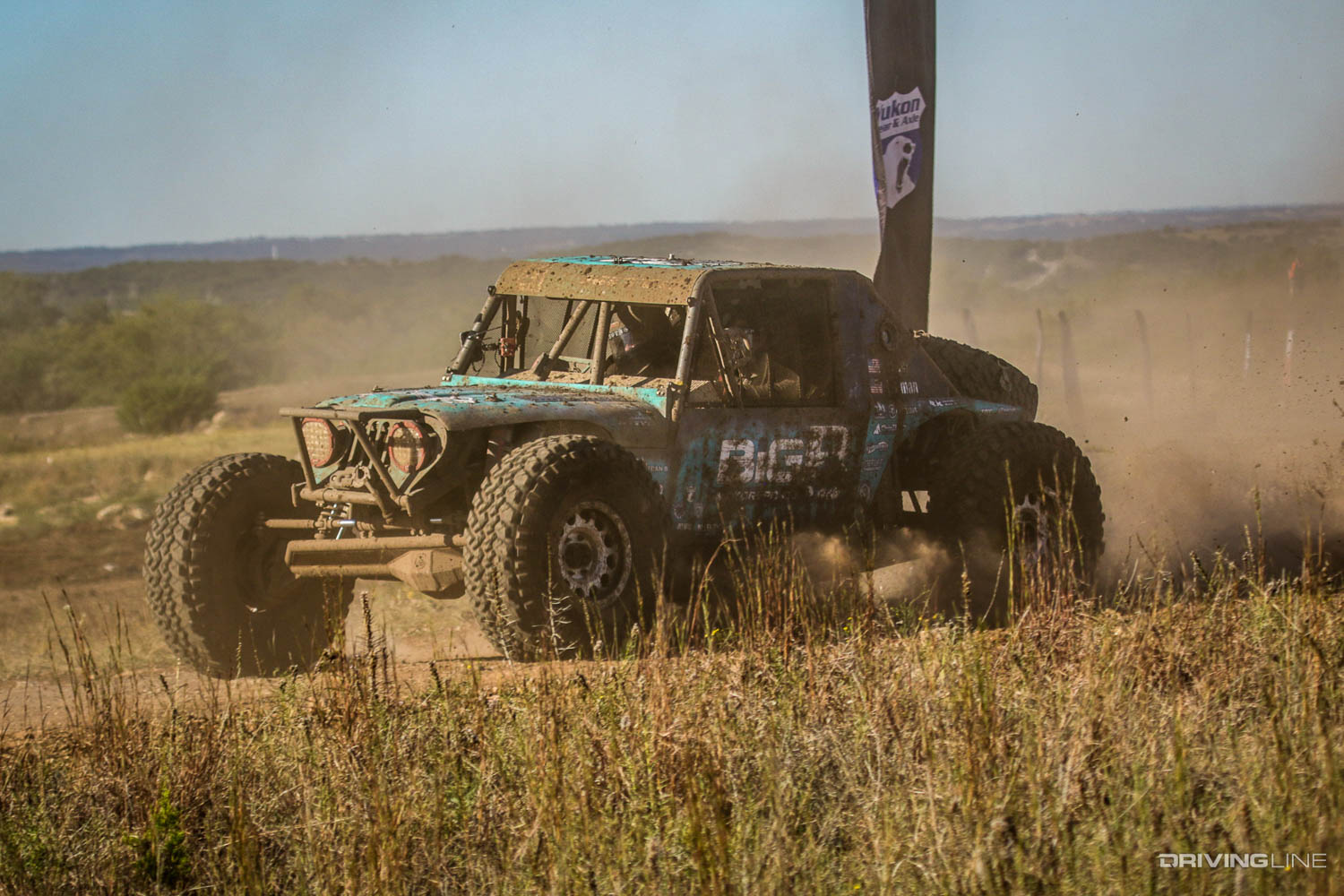 Josh Blyler racing around a corner and kicking up dirt