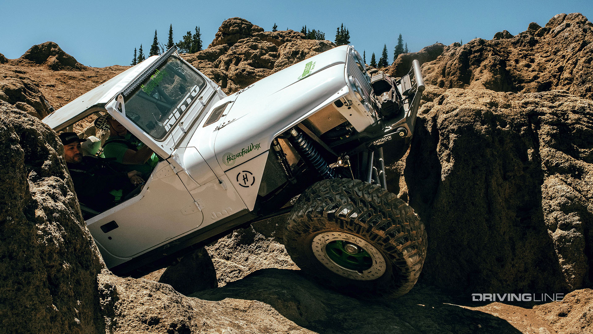jeep scaling rock obstacle on nitto tires