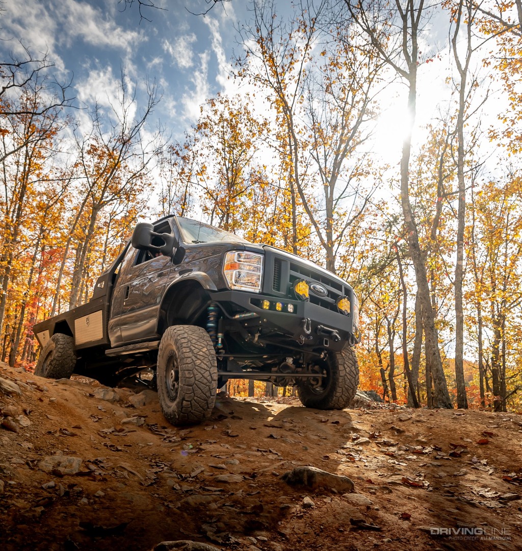 2021 Ford E350 4x4 flatbed van driving off-road