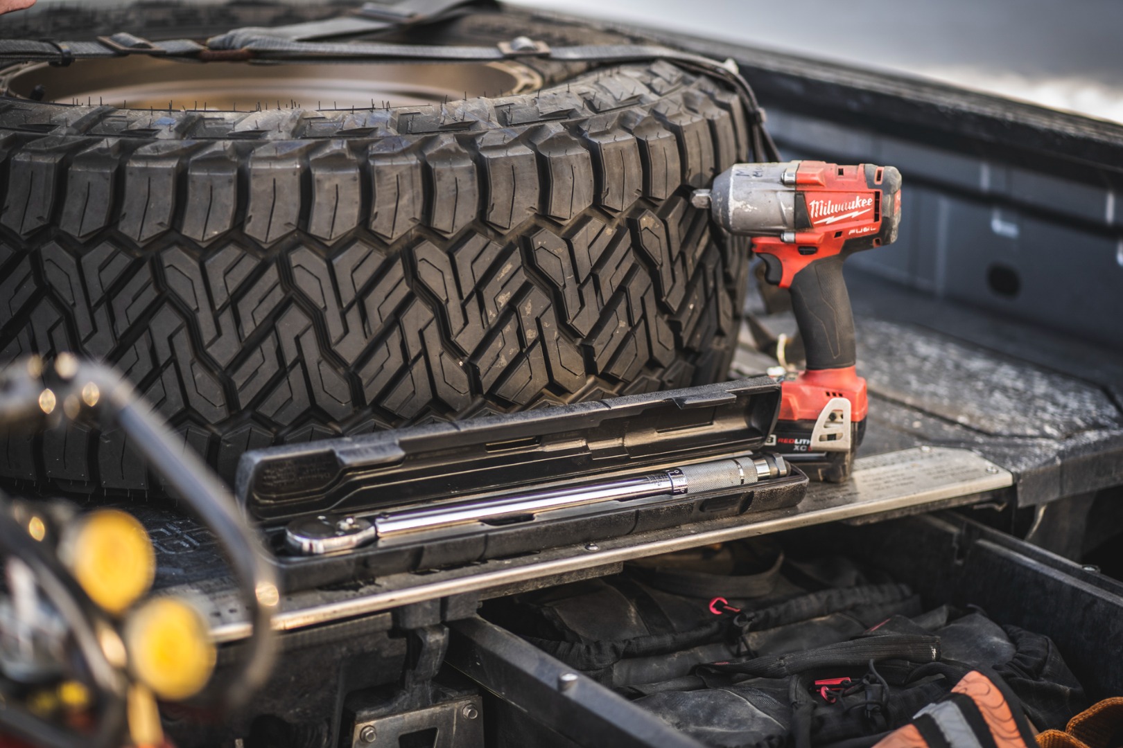 Torque Wrench in a truck bed next to a Nitto Recon Grappler tire