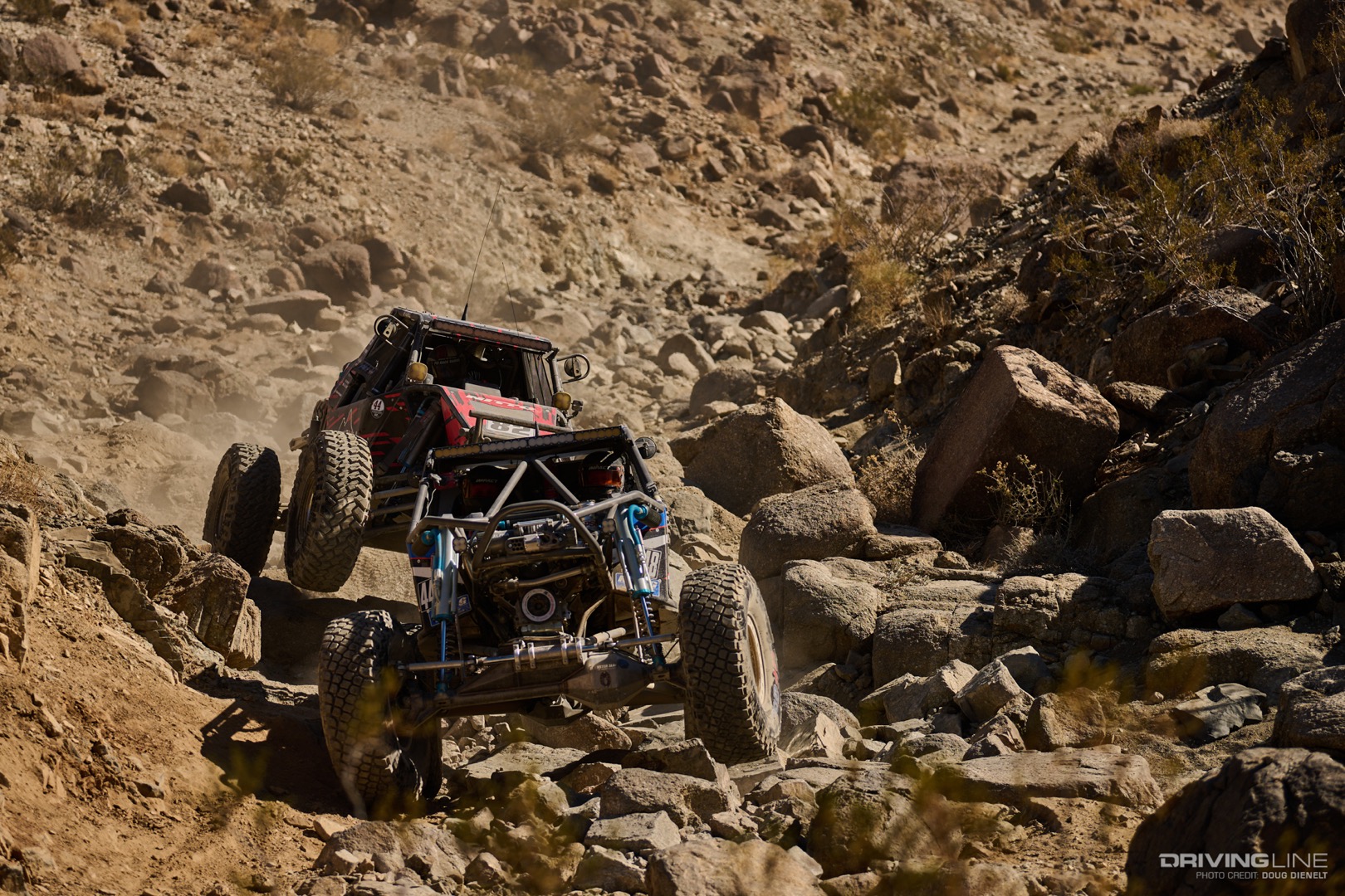 JP Gomez behind Randy Slawson as they drive through a rocky canyon