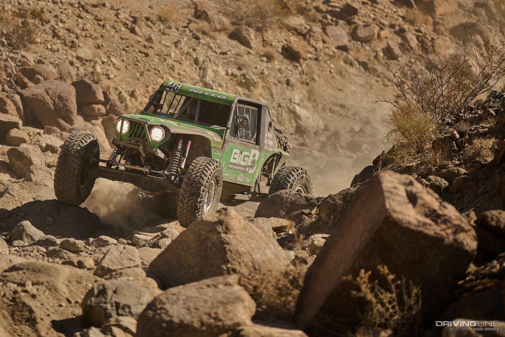 Rusty Blyler drives over boulders in a canyon