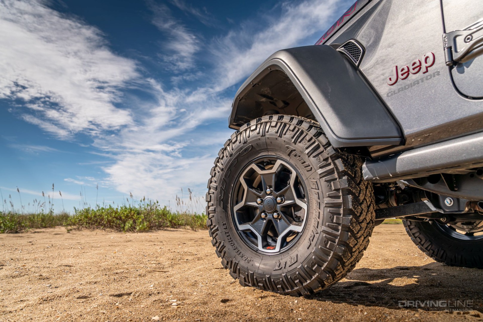 front wheel of a Jeep on sandy beach with 35-inch Nitto Trail Grappler Tires