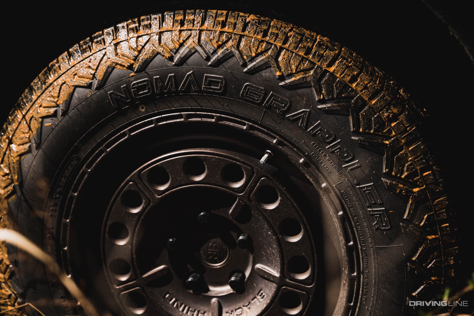 Nitto Nomad Grappler covered in red clay