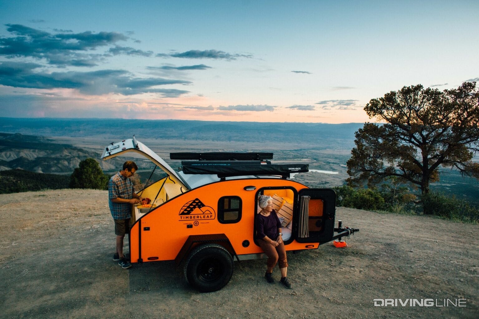 Teardrop camping trailer off-road in orange