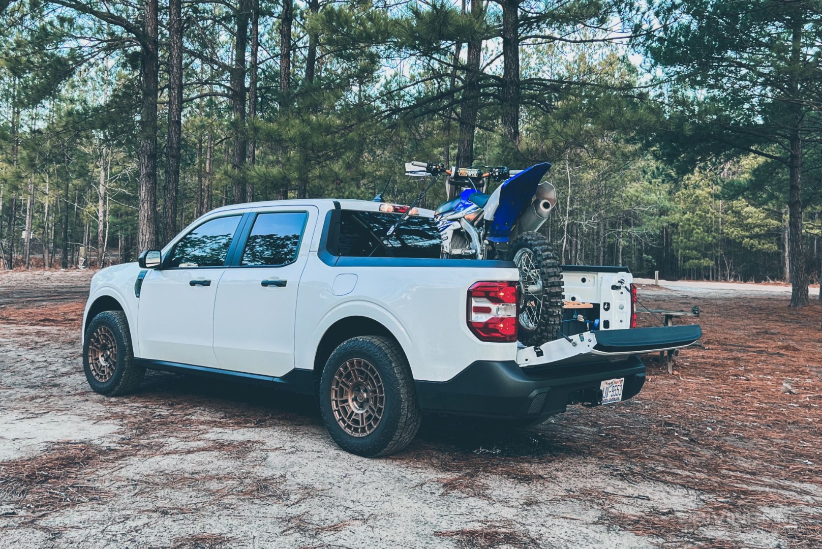 dirt bike in the bed of 2022 Ford Maverick XL Hybrid on Nitto Tire Nomad Grappler
