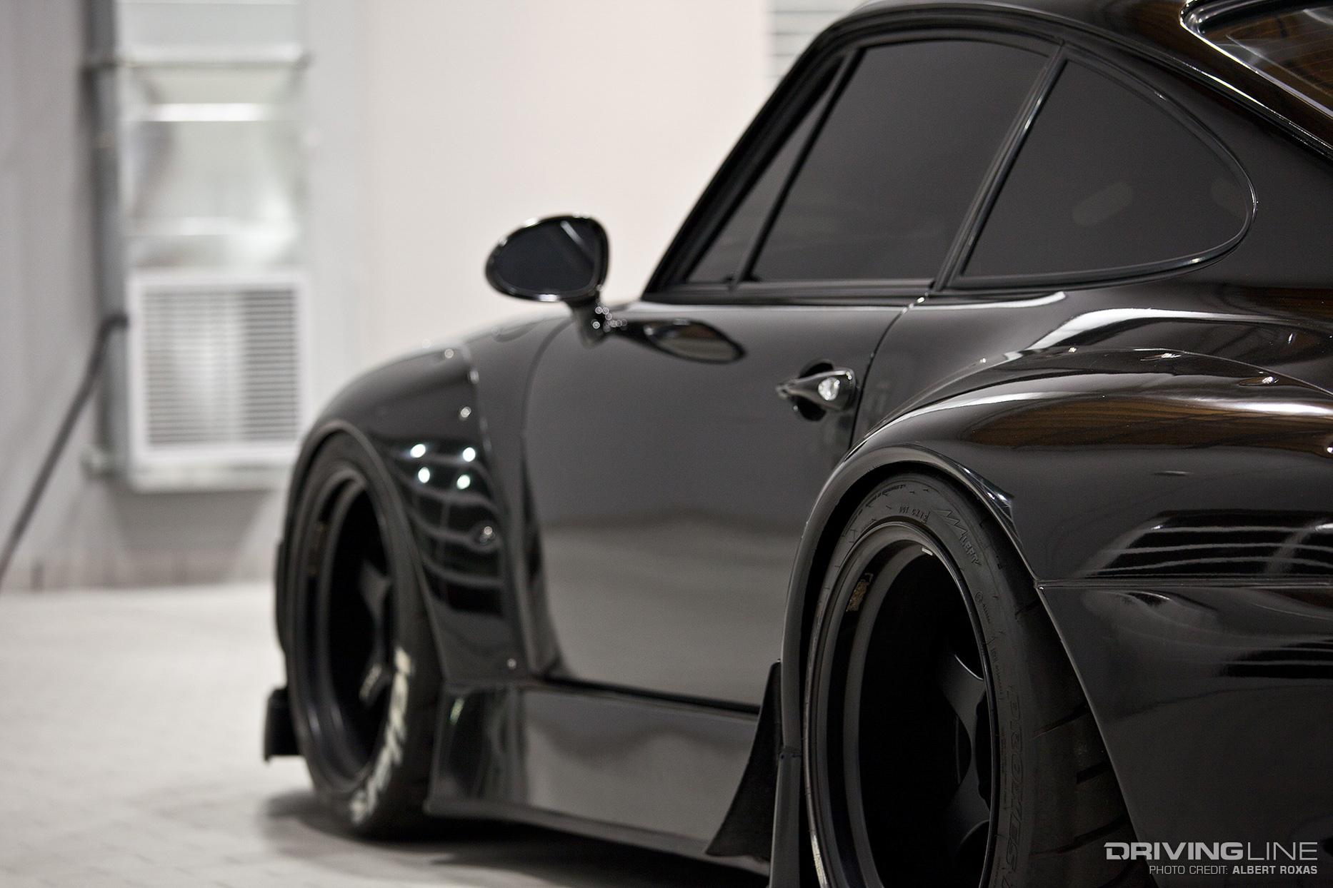 driver side view of black RWB Porsche