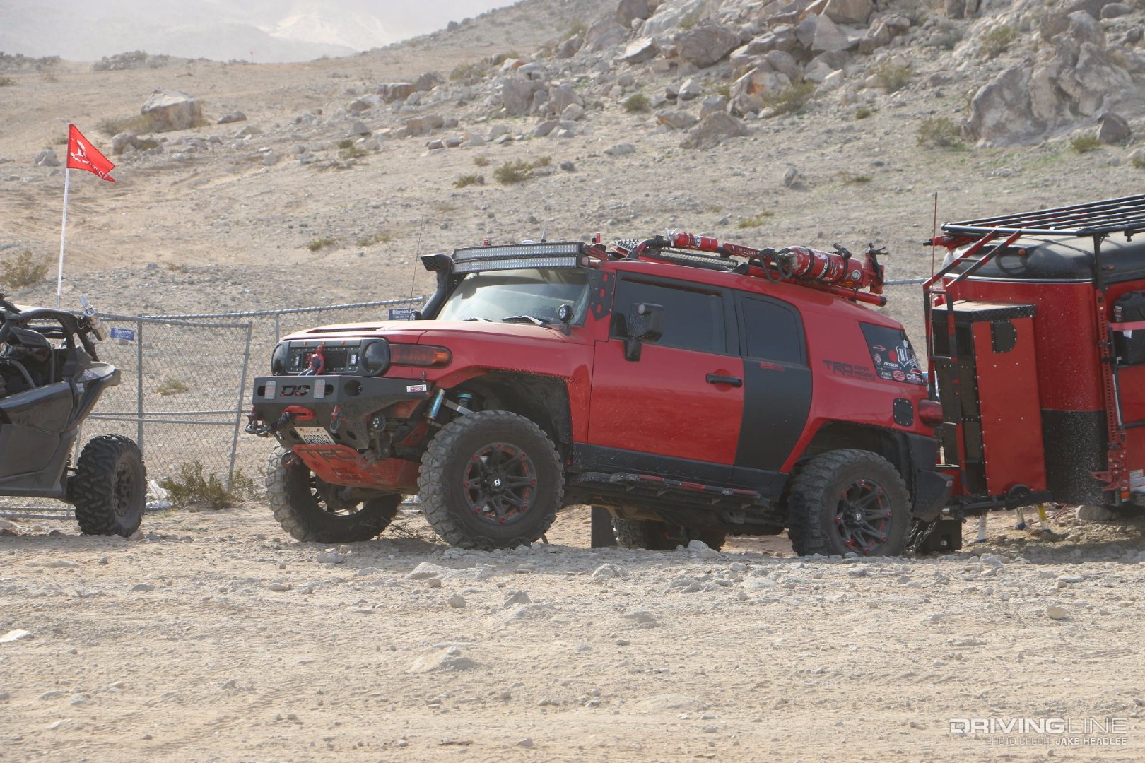 Red and Black Toyota FJ Cruiser with a snorkel and light bar
