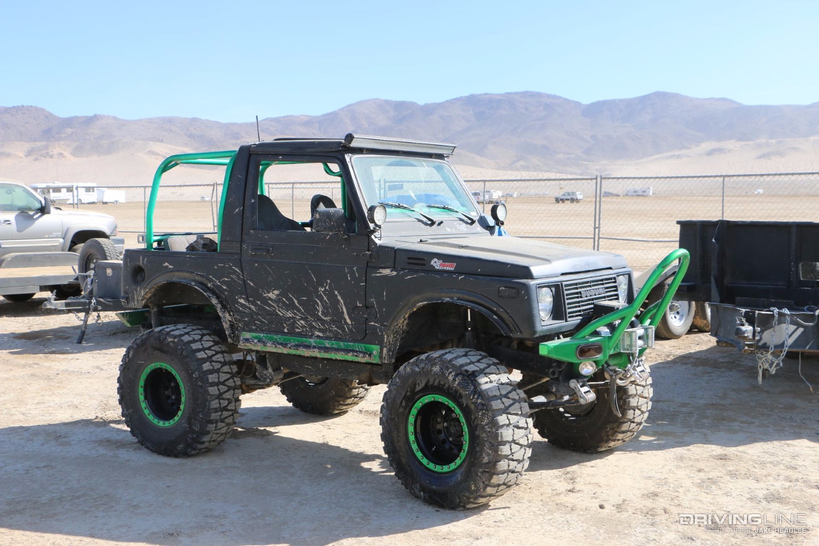Black and green Suzuki Samurai with no top and a winch
