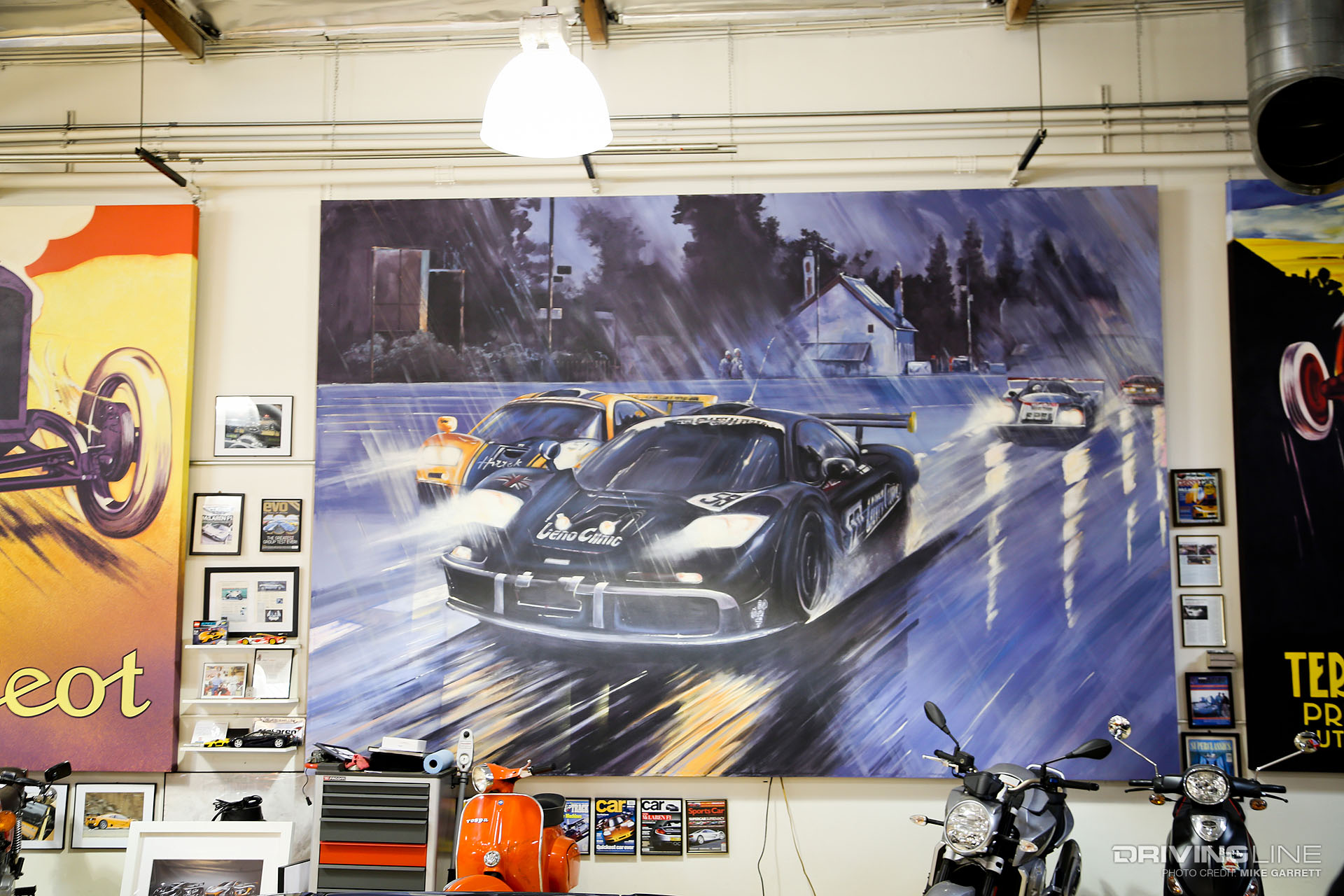 Painting of race cars racing through the rain