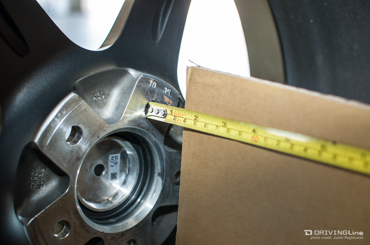 Tape measure against a wheel and piece of cardboard