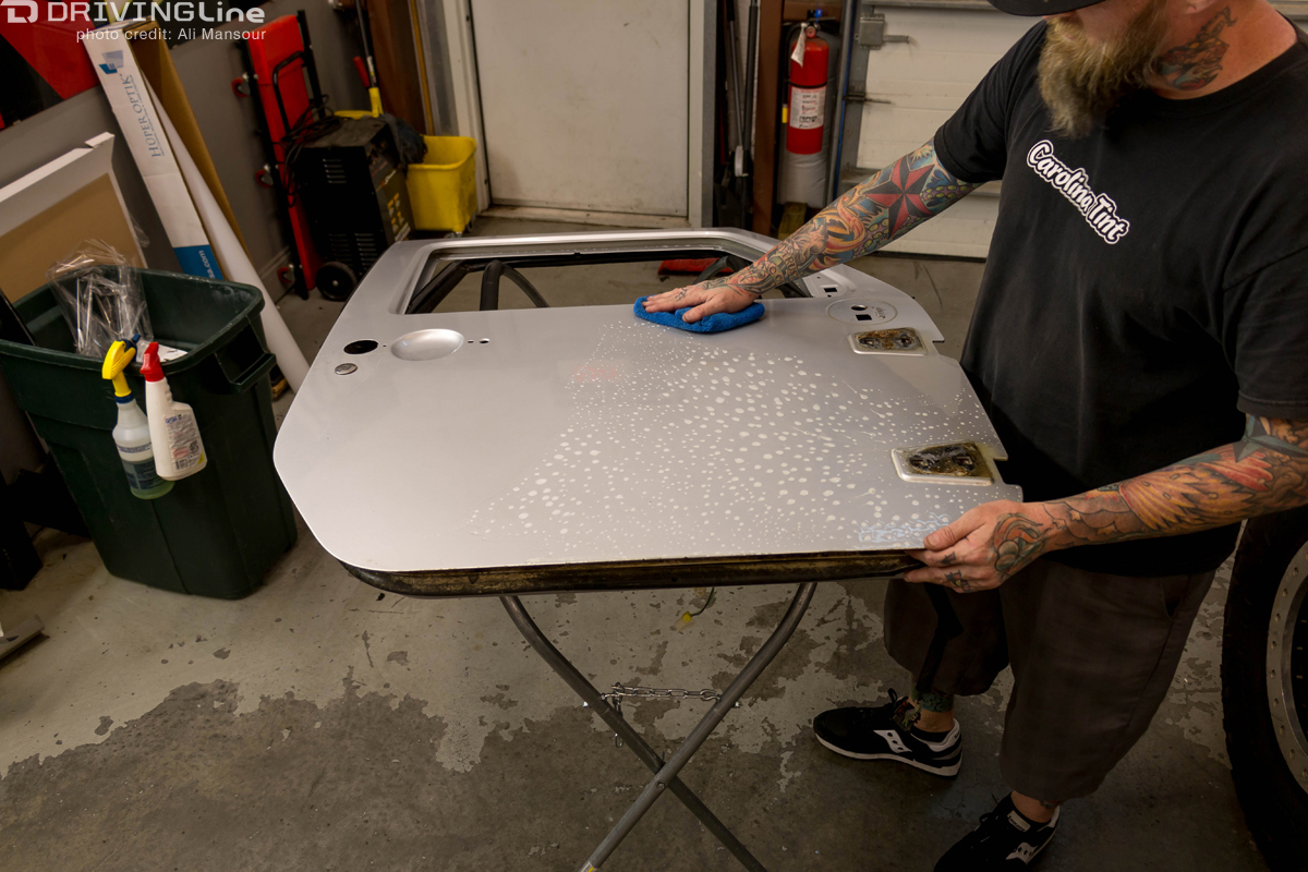 Man washing a Jeep Wrangler door