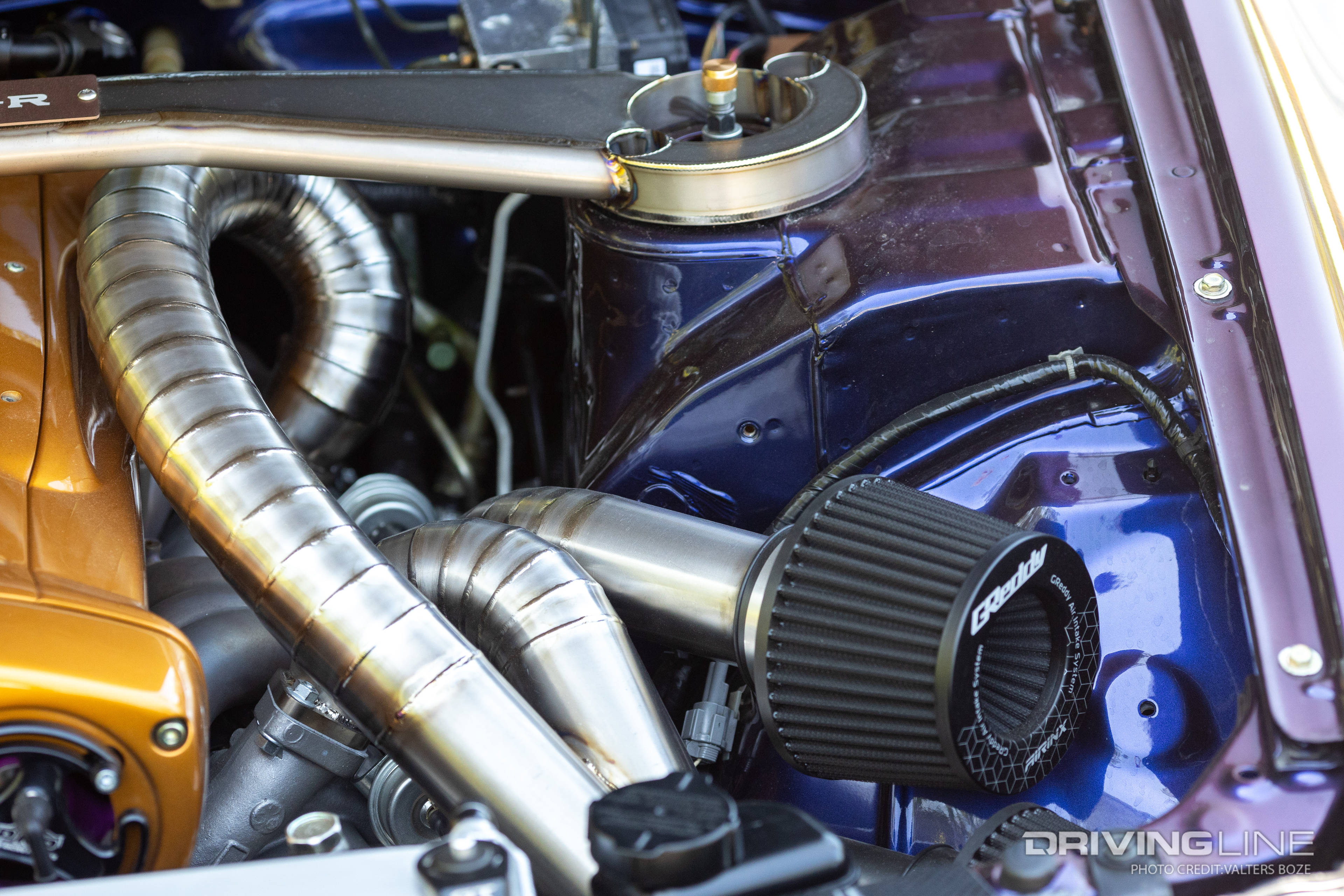 The routing of the intake and turbo piping was very meticulously planned out in the engine bay of Adam LZ's R34 Skyline