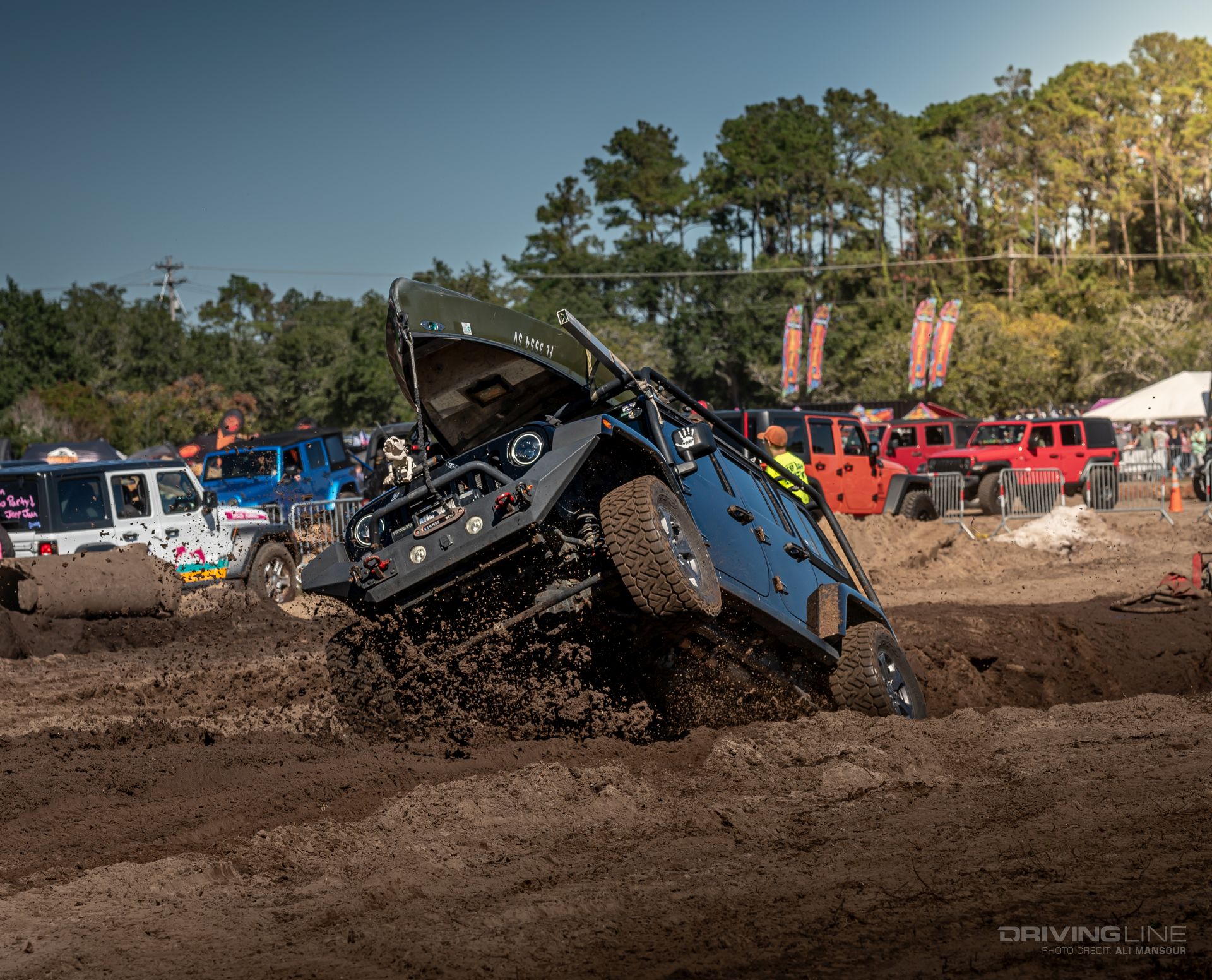 MB Jeep Jam JK on Recon Grapplers jumping out of mud pit
