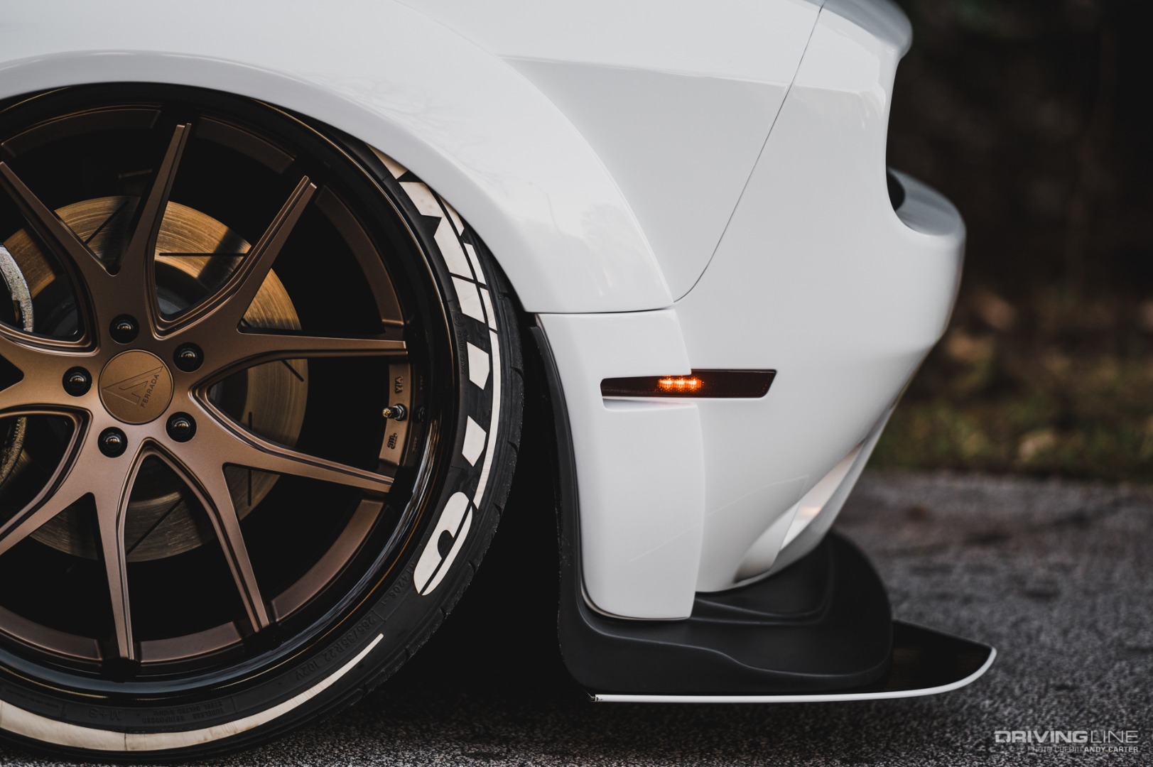 Dodge Challenger white lowered on Nittos front wheel close-up